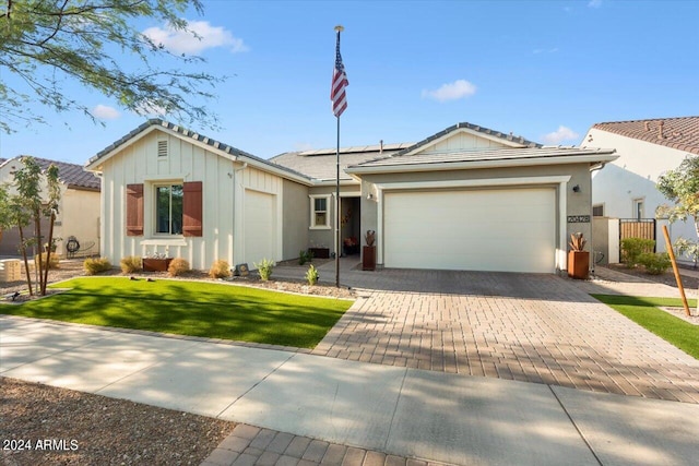 ranch-style house with a garage and a front lawn