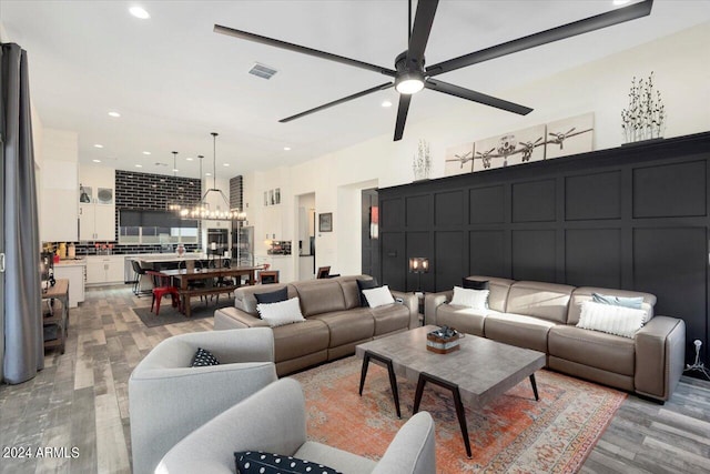 20428 W Elm Dr, Buckeye, AZ 85396 - living room with light wood-type flooring, a ceiling fan, a chandelier, and recessed lighting