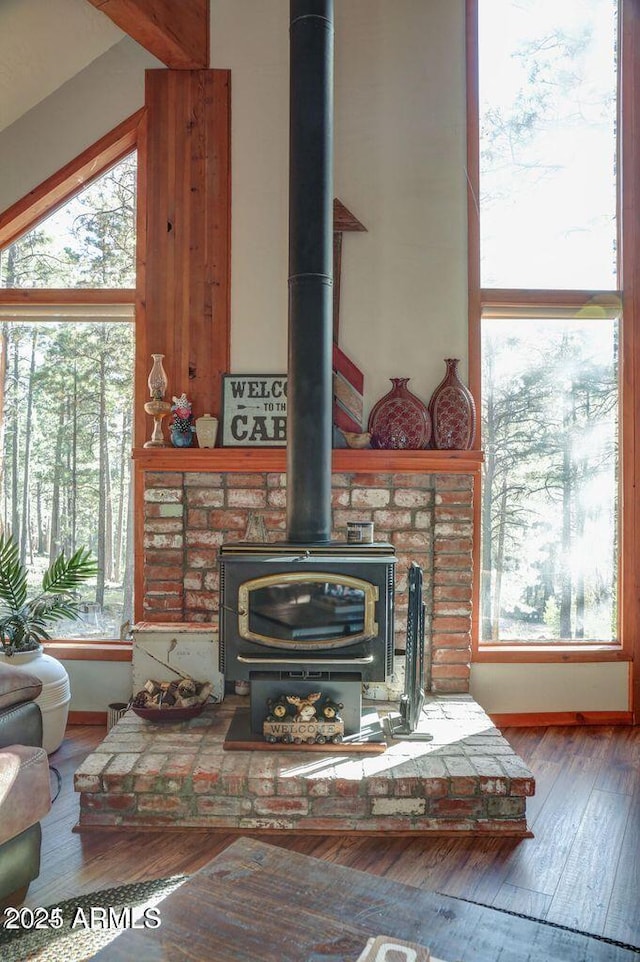 details with a wood stove and wood finished floors