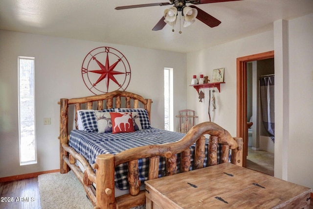 bedroom with ceiling fan, multiple windows, baseboards, and wood finished floors