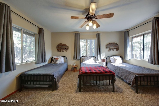 carpeted bedroom featuring a ceiling fan and baseboards