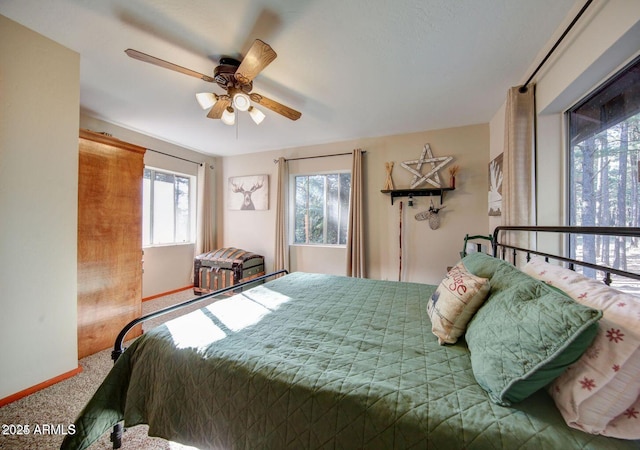 bedroom with carpet, baseboards, and ceiling fan