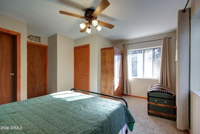 carpeted bedroom featuring a ceiling fan and baseboards