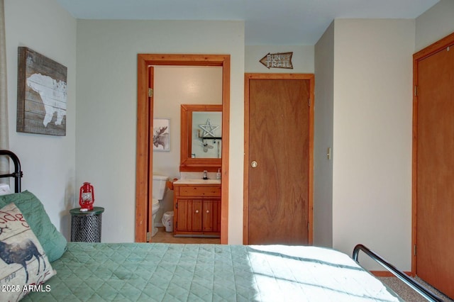 bedroom featuring a sink and ensuite bathroom