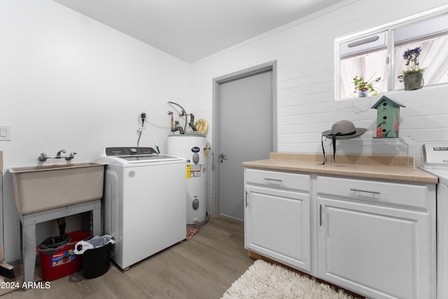 laundry area with sink, cabinets, electric water heater, washer / clothes dryer, and light wood-type flooring