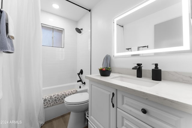 full bathroom featuring shower / bath combination with curtain, vanity, hardwood / wood-style flooring, and toilet