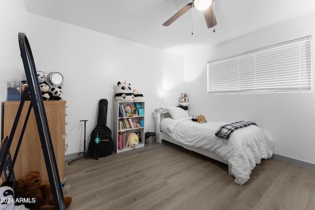 bedroom with hardwood / wood-style floors and ceiling fan