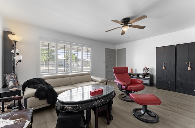 living room with hardwood / wood-style floors and ceiling fan