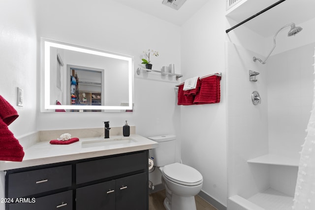 bathroom featuring toilet, vanity, wood-type flooring, and a shower with shower curtain