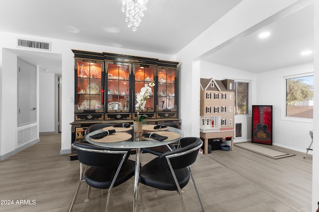 dining area with a chandelier and hardwood / wood-style flooring