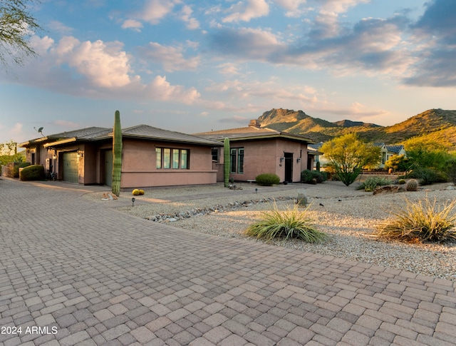 view of front facade with a mountain view and a garage