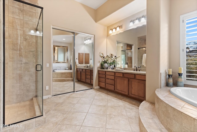 bathroom with vanity, tile patterned flooring, and plus walk in shower