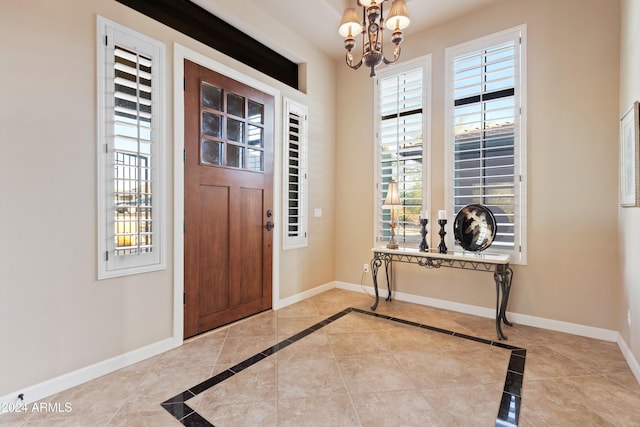 foyer entrance featuring a notable chandelier and light tile patterned floors