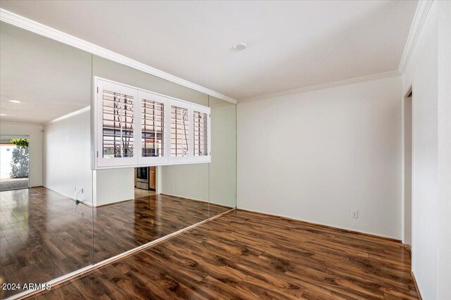 unfurnished living room featuring ceiling fan, dark wood-type flooring, and crown molding