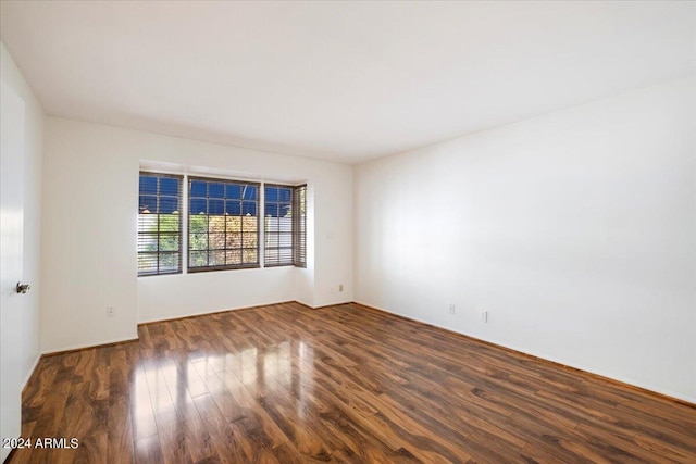 spare room featuring dark hardwood / wood-style floors