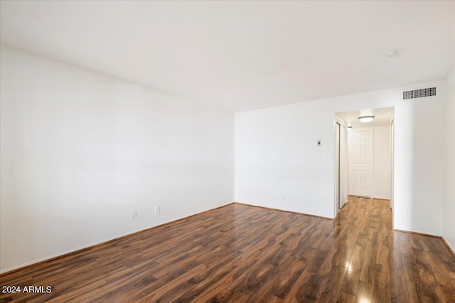 spare room featuring dark hardwood / wood-style flooring