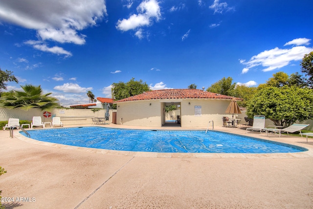 view of swimming pool with a patio area