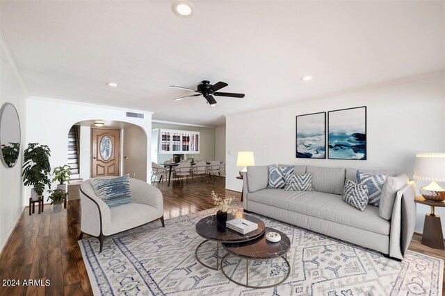 empty room with ceiling fan, ornamental molding, and dark wood-type flooring