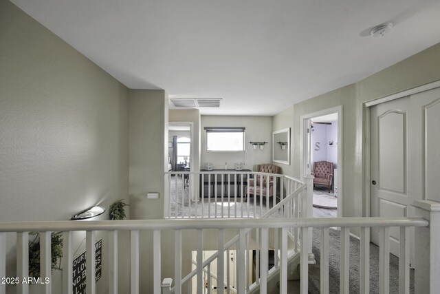 hallway featuring visible vents