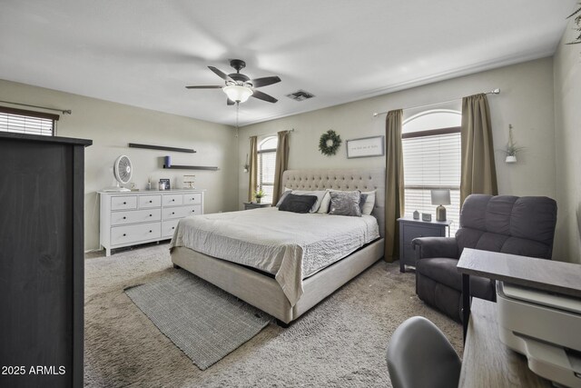 carpeted bedroom featuring visible vents and ceiling fan