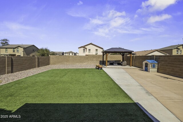 view of yard featuring a gazebo, a patio area, a residential view, and a fenced backyard