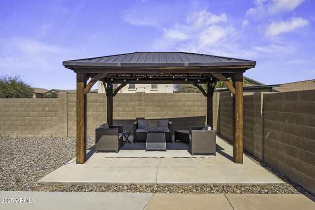 view of patio / terrace with a gazebo, a fenced backyard, and an outdoor living space