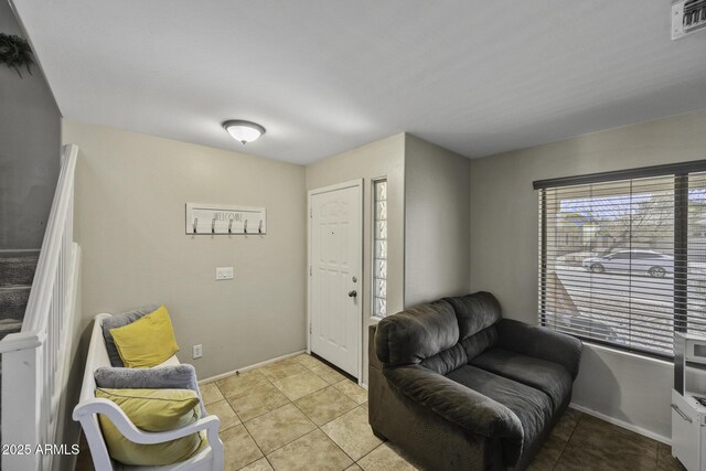 interior space featuring light tile patterned floors, visible vents, and baseboards