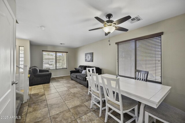 dining space featuring tile patterned floors, visible vents, and ceiling fan