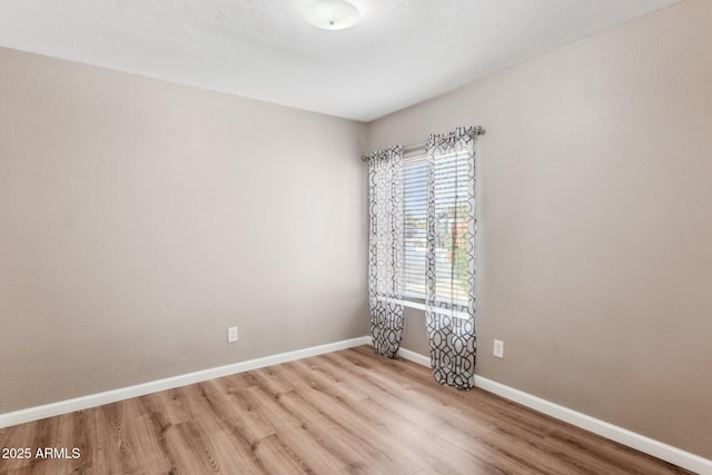 unfurnished room with light wood-type flooring