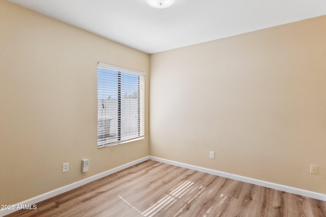 unfurnished room with light wood-type flooring