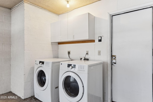 clothes washing area with washing machine and dryer