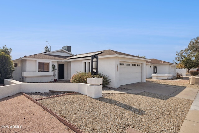 ranch-style home with cooling unit and a garage