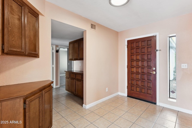 foyer entrance with light tile patterned floors