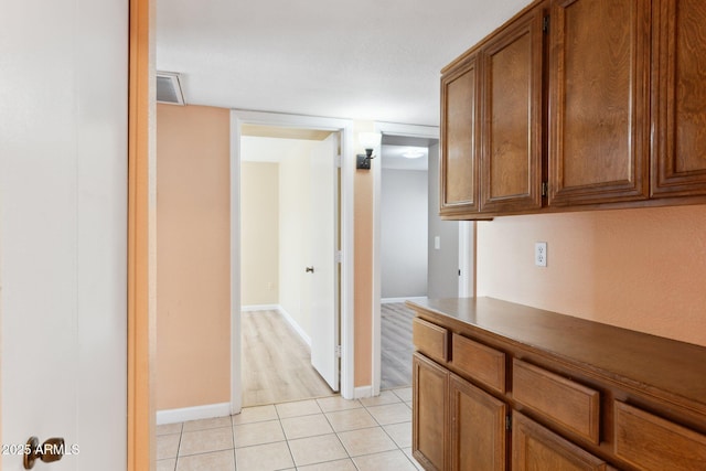 hallway featuring light tile patterned floors