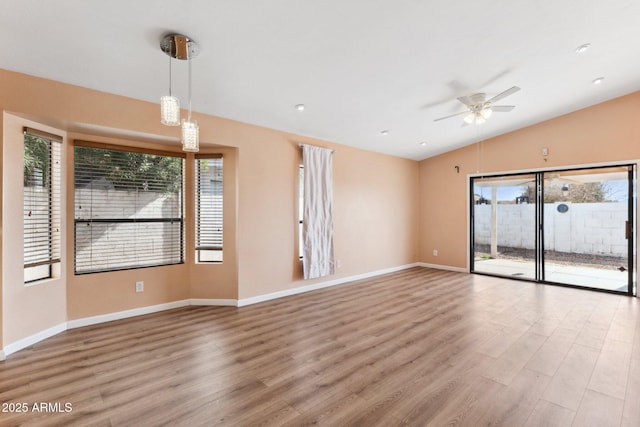 unfurnished living room featuring ceiling fan, lofted ceiling, and hardwood / wood-style floors