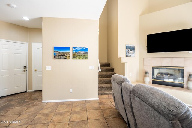 living room with recessed lighting, baseboards, a fireplace, and stairs