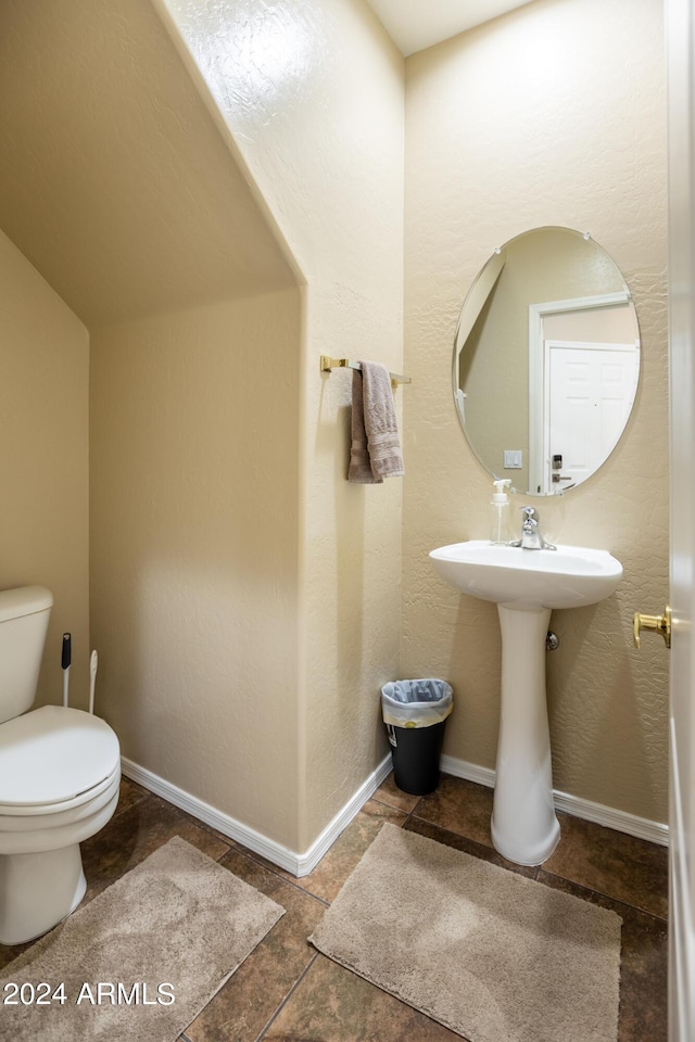 half bathroom featuring toilet and a sink