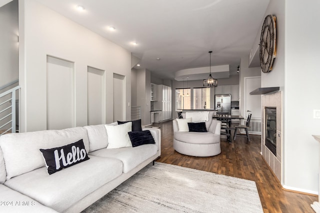 living room with a notable chandelier and dark hardwood / wood-style floors