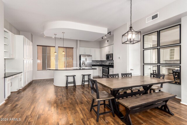 dining area with a chandelier and dark hardwood / wood-style floors