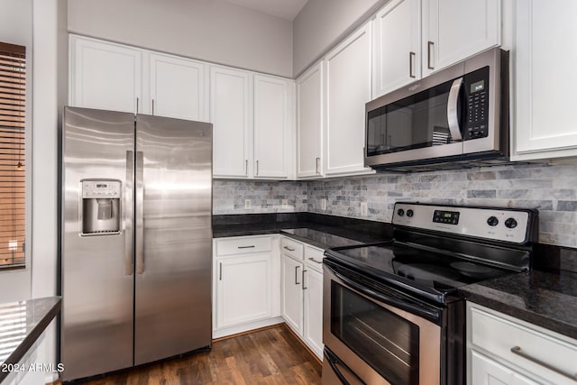 kitchen with tasteful backsplash, dark hardwood / wood-style flooring, white cabinetry, stainless steel appliances, and dark stone countertops