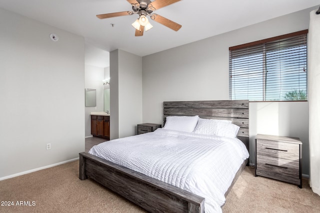 carpeted bedroom featuring ensuite bath and ceiling fan