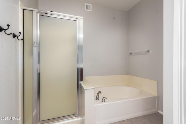 bathroom with tile patterned floors and independent shower and bath