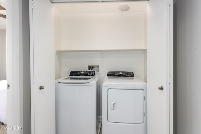 clothes washing area featuring washing machine and clothes dryer