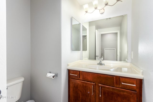 bathroom with toilet and vanity