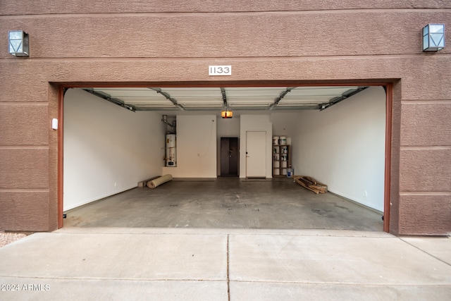 garage featuring a garage door opener and secured water heater