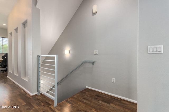 stairs featuring vaulted ceiling and hardwood / wood-style flooring