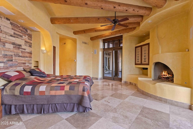 bedroom featuring a large fireplace, access to outside, visible vents, and beam ceiling