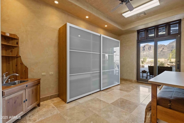 interior space with a mountain view, a sink, visible vents, and baseboards