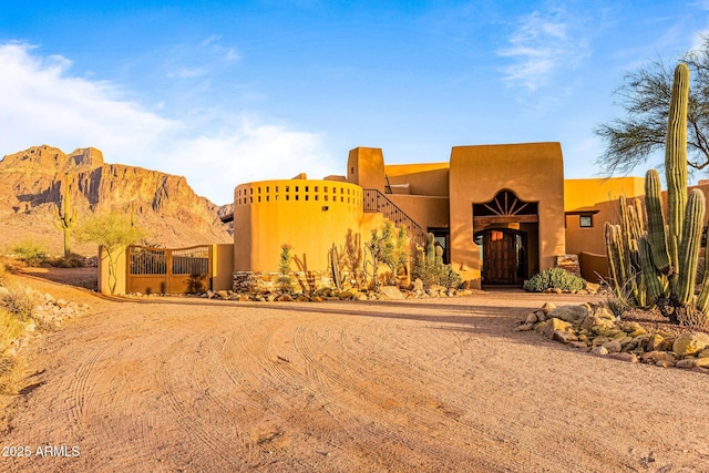 pueblo revival-style home featuring a mountain view