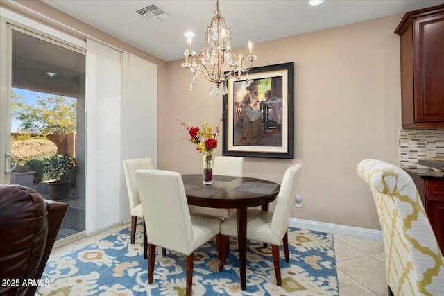 dining room with a chandelier and light tile patterned floors